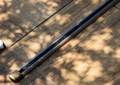 Rail de la Coverseal parfaitement intégré dans le revêtement bois de la terrasse, pour une esthétique discrète et élégante.