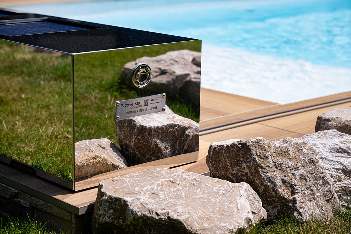 Détail rapproché de l'habillage effet miroir Coverseal installé au bord de la piscine, reflétant élégance et robustesse.